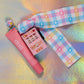 Full view of the adorable pink Mini Slot Machine accessory, shown with the pastel pink lip balm prop and the Kawaii Gingham Ribbon lanyard