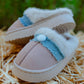 Side angle view of kids fluffy smiley slip-on slippers with plush lining and lightweight sole