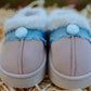 Front view of kids fluffy smiley slip-on slippers showing denim trim and smiley button