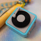 Close-up of the Mini Turntable Charm, highlighting the black vinyl record detail and the light blue casing