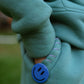 Close-up sleeve detail of mint green kids fleece jogger set with decorative hand stitching