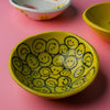 Hand-painted yellow ceramic bowl featuring multiple smile face illustrations