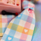 Detail of the Pastel Gingham Ribbon lanyard, which features a sweet plaid pattern in pink, yellow, and blue with tiny white heart accents