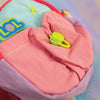 Full view of the chunky Miniature Backpack charm in pink and blue, featuring heart decals, white straps, and a pink paracord
