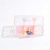 Clear peace and love themed storage box with star detail and colorful charm inside