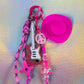 Pop Punk Key Charm showcasing the pink and black paracord and the pale pink peace sign bead