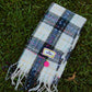 Plaid Big Dreamer scarf in navy and bright pink with stitched label and smiley charm