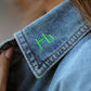 Close-up of neon stitch detail on the collar of the Pocket Full of Dreams denim shirt