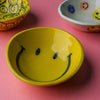 Hand-painted yellow ceramic smile bowl with glossy finish and happy face detail
