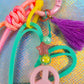 Detail shot of the top charm assembly: teal heart, pink star bead, mint bead, and the contrasting purple tassel on the Mint Mellow Key Charm