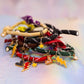 Side view of a large, colorful stack of the "Cool Kids" cord bracelets, highlighting the different textures and charms, such as black stars and red lightning bolts