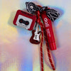 Full view of the chunky Rock and Roll keychain featuring a red retro cassette tape and a red glitter electric guitar charm