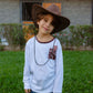 Kid wearing Wilder Than The West long sleeve t-shirt with cowboy hat outdoors