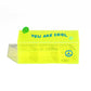 Neon yellow plexiglass organiser box with “You Are Cool” text and peace sign detail on the front