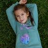 Kids mint green fleece jogger set with You Rock print and hand stitch pocket detail worn outdoors