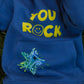 Close-up of You Rock slogan on front of denim blue kids fleece hoodie