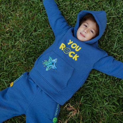 Child wearing You Rock denim blue fleece hoodie and jogger set outdoors