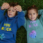 Lifestyle image of kids wearing You Rock mint green fleece jogger sets