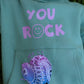 Close-up of You Rock slogan on mint green kids fleece sweatshirt with stitched character patch